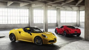 A yellow and red Alfa Romeo 4C in a light-filled industrial hangar