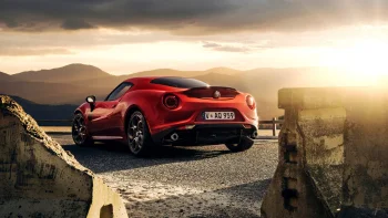 a red alfa romeo 4c against a mountain backdrop, bathed in the rays of the setting sun, alfa romeo 4c red, alfa romeo, cars, automobiles, clouds, compartment, evening, evenings, twilight, dus, landscapes, mountains, peaks, hills, roads, highways, motorways, avenues, driveways, passageways, sports cars, sun, sun rays, sunlight, rays, sunsets, sunset, auto, vehicles