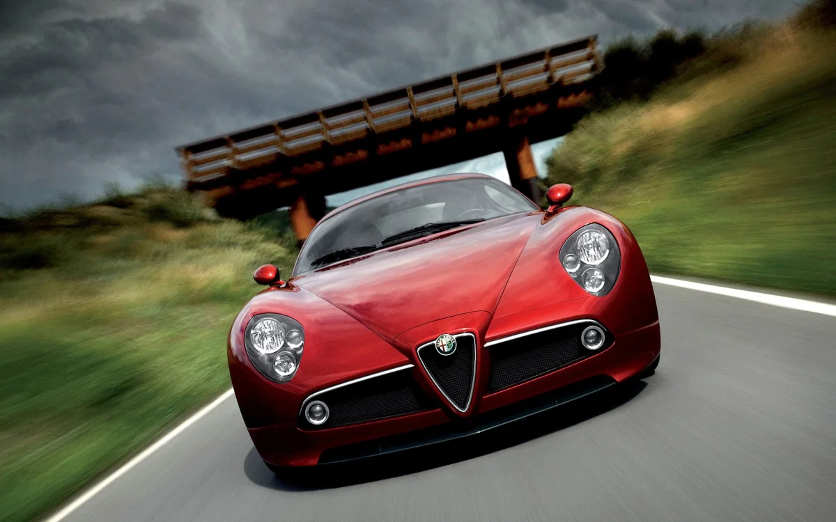 A red Alfa Romeo 8C Competizione on the highway