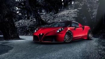 A red Alfa Romeo 4C on a winding forest road