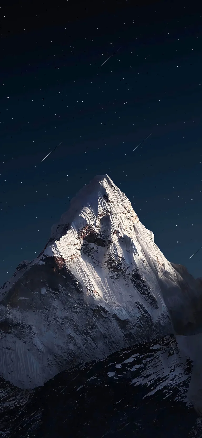 A snow-capped peak under the starry sky of the Alps
