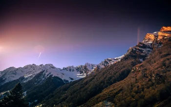 the first rays of the sun on the snow-covered slopes of the alps, alps, forest, forests, landscapes, mountains, peaks, hills, sky, snow, sun, sun rays, sunlight, rays, sunrises, dawn, nature, world