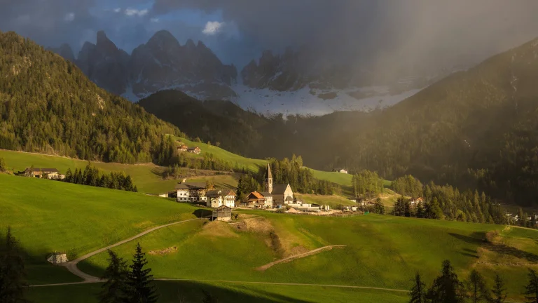 the rays of the setting sun over an italian village, alps, churches, clouds, forest, forests, houses, buildings, italy, landscapes, mountains, peaks, hills, sunsets, sunset, valleys, villages, settlements, nature, world