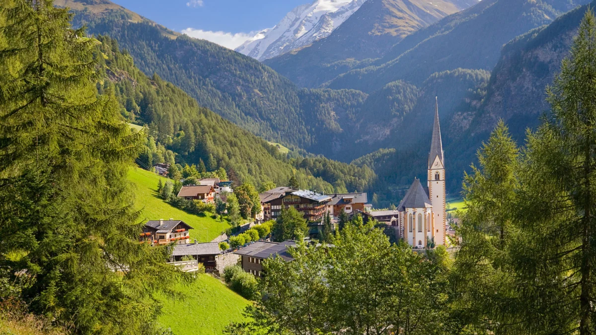 the austrian village of heiligenblut, surrounded by snow-capped peaks, the alps, austria, alps, cathedrals, churches, fir trees, coniferous trees, forest, forests, landscapes, little houses, huts, cottages, mountains, peaks, hills, snow, villages, settlements, nature, world