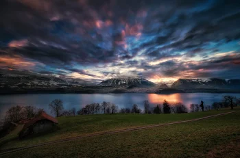 the sunset sky over lake thun in the swiss alps, alps, clouds, lakes, bodies of water, landscapes, little houses, huts, cottages, mountains, peaks, hills, roads, highways, motorways, avenues, driveways, passageways, sunsets, sunset, switzerland, trees, nature, world