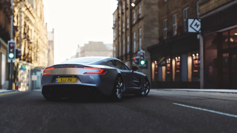 aston martin one-77 на порожній міській вулиці, aston martin one 77, aston martin, астон мартін, будинки, будівлі, вечір, вечори, сутінки, вулиці, дороги, шляхи, траси, шосе, магістралі, автостради, проспекти, проїзди, захід сонця, машини, автомобілі, спорткари, авто