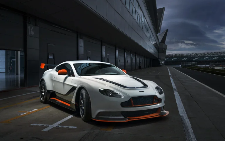 білосніжний aston martin vantage gt3 на піт-лейні гоночної траси, aston martin vantage gt3 special edition, aston martin, астон мартін, будинки, будівлі, машини, автомобілі, небо, спорткари, хмари, авто