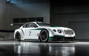 A Bentley Continental GT3 race car in a well-lit pit