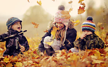 Three children are enjoying the golden autumn in the park