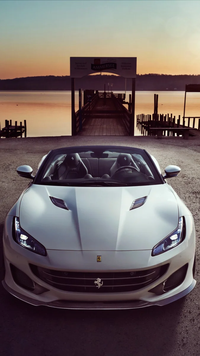 Белоснежный Ferrari Portofino на фоне заката у озера Аммерзе