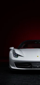 A snow-white Ferrari 458 Italia in deep shadow