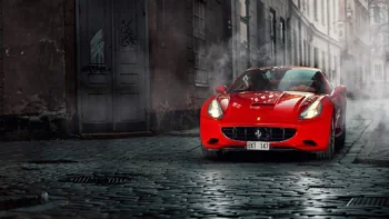 A Ferrari California on the cobblestones of an old European city