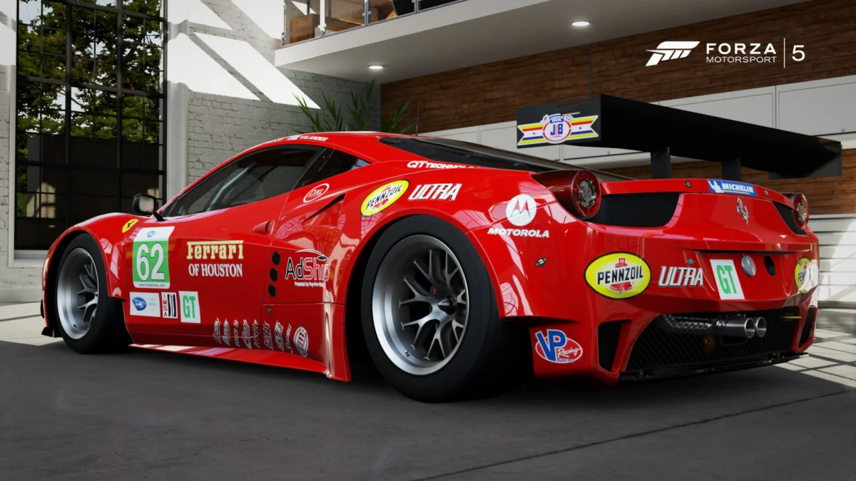 A Ferrari 458 Italia GT2 race car in a modern garage