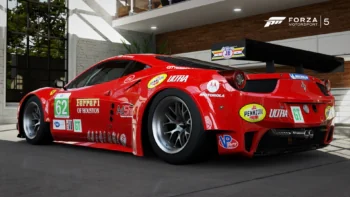 A Ferrari 458 Italia GT2 race car in a modern garage