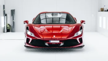 A red Ferrari F8 Tributo in the studio's sterile environment