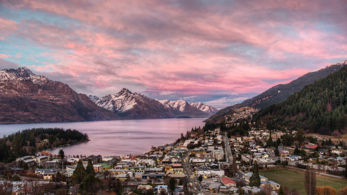 A pink sunset over Queenstown and Lake Wakatipu in New Zealand