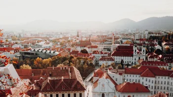 view of the kunsthaus graz and st. egidius cathedral in austria, kunsthaus graz, austria, autumn, autumns, cities, city, cityscape, cityscapes, fog, graz, houses, buildings, morning, mountains, peaks, hills, roofs, sunrises, dawn, temples, architecture, world