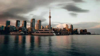 a morning view of toronto's skyscrapers and the cn tower from the water, cn tower, toronto, canada, cities, city, cityscape, cityscapes, clouds, contemporary architecture, lakes, bodies of water, morning, sky, skyscrapers, sunrises, dawn, yachts, architecture, world