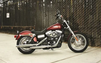 a burgundy harley-davidson dyna motorcycle by a chain-link fence, harley-davidson dyna, cruiser motorcycles, cruisers, american classic motorcycles, harley-davidson, motorcycles, bikes, roads, highways, motorways, avenues, driveways, passageways, spokes, harley davidson, technology