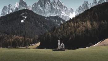 St. John's Church against the backdrop of the snow-capped Dolomites in Italy