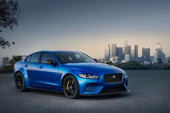 A blue Jaguar XE SV Project 8 against the backdrop of Los Angeles at dusk