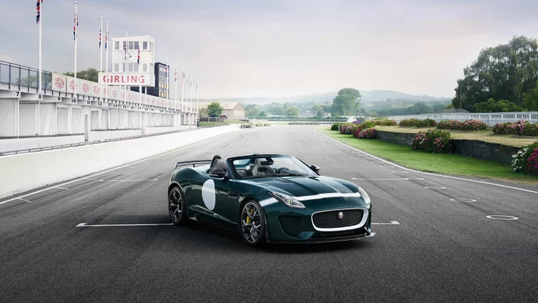 A green Jaguar Project 7 on the empty Goodwood race track