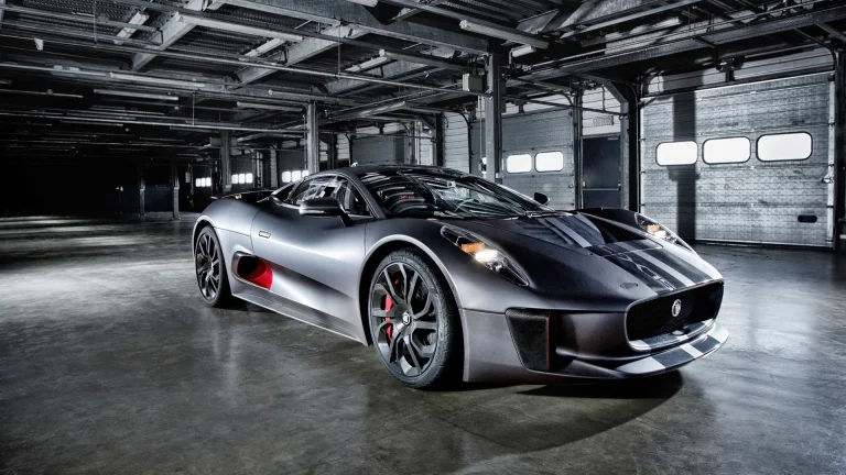 A matte-finish Jaguar C-X75 in a well-lit industrial hangar