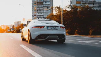 A white Jaguar F-Type on city streets