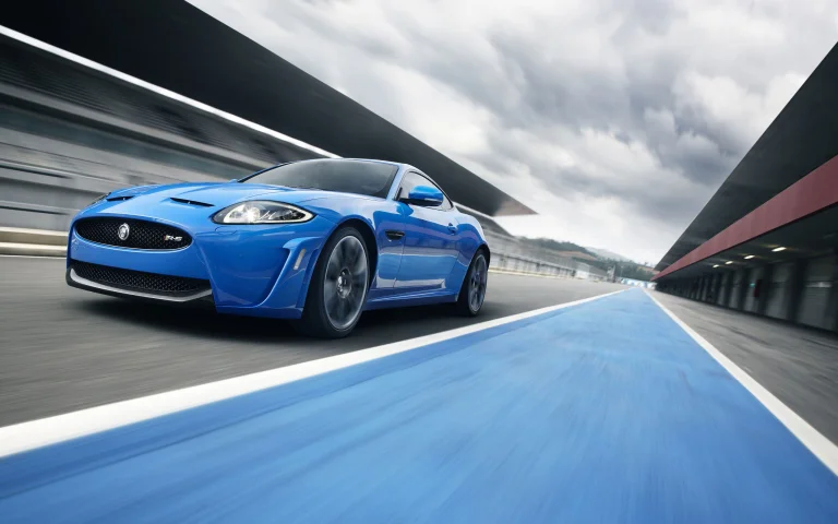 A blue Jaguar XKR-S on the race track