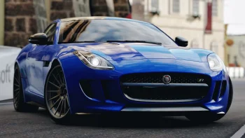A blue Jaguar F-Type on city streets