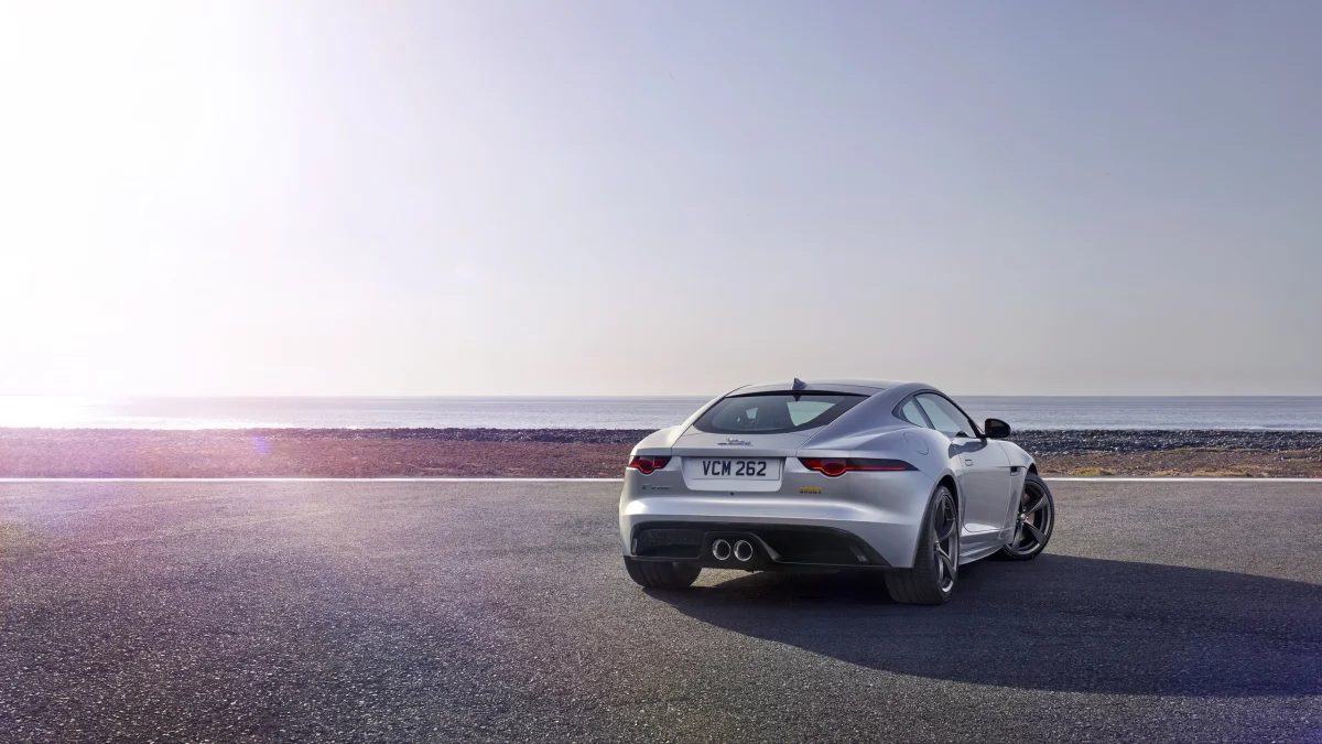 A silver Jaguar F-Type against the backdrop of the seashore