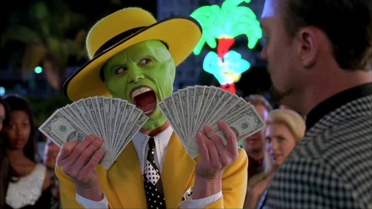 Stanley Ipkis as the Mask, holding wads of dollar bills in the neon light