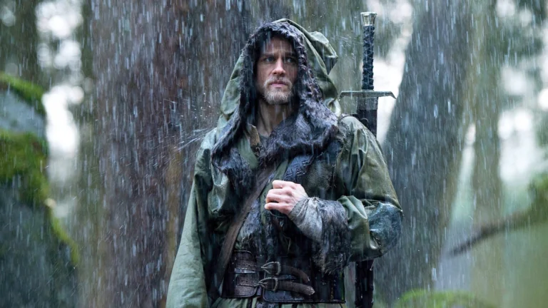 Charlie Hunnam as King Arthur in the pouring rain in the forest