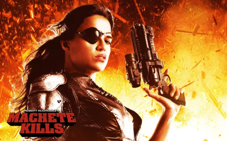 Michelle Rodriguez as Sheez in the movie "Machete Kills", against a backdrop of flashes of fire