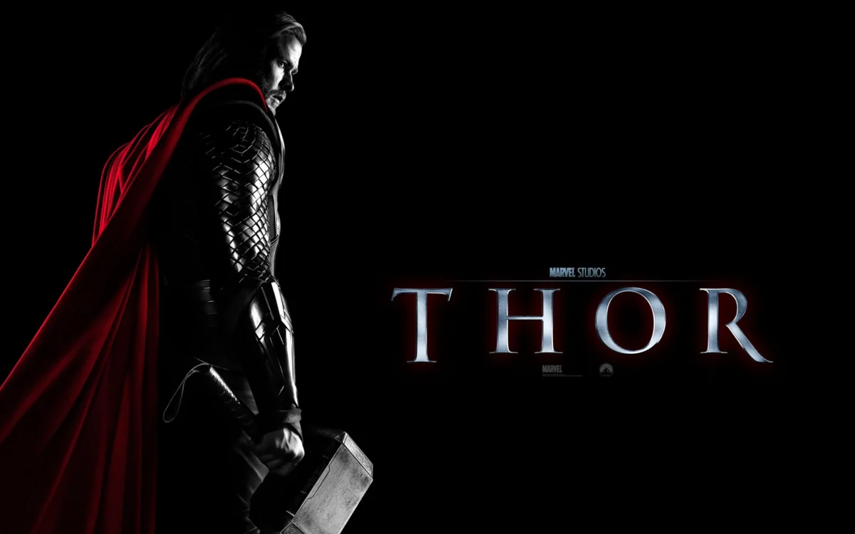 Chris Hemsworth as Thor with the hammer Mjölnir against a dark background