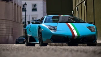 A blue Lamborghini Murcielago on a narrow city street