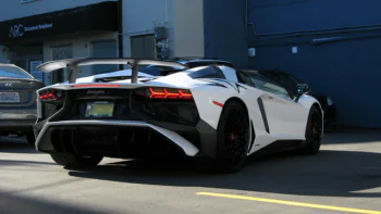 A white Lamborghini Aventador in a parking lot in Vancouver