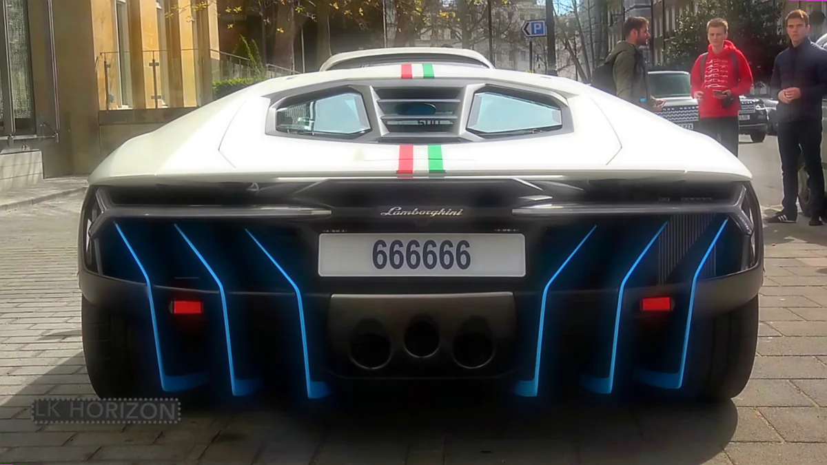 A white Lamborghini Centenario with the Italian tricolor on a city street