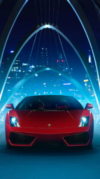 A red Lamborghini Gallardo against the backdrop of the city at night