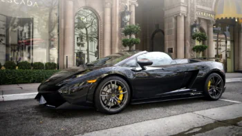A black Lamborghini Gallardo LP 570-4 Spyder Performante on a city street