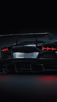 A black Lamborghini Aventador with an aggressive rear wing in the twilight