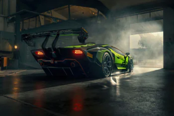The Lamborghini Essenza SCV12 race car bathed in light in the garage