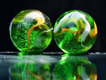 Green glass balls on a black background