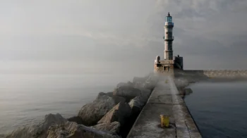 An old lighthouse in the foggy harbor of Chania on the island of Crete