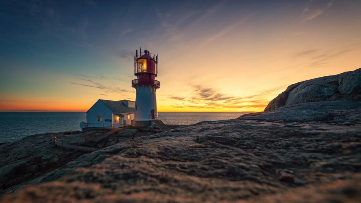The Lindesnes Lighthouse against the backdrop of the sunset sky in Norway