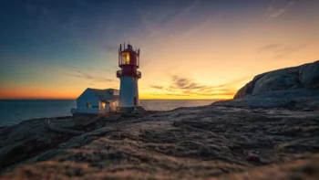 The Lindesnes Lighthouse against the backdrop of the sunset sky in Norway