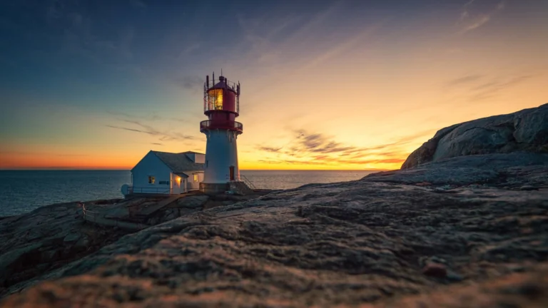 The Lindesnes Lighthouse against the backdrop of the sunset sky in Norway