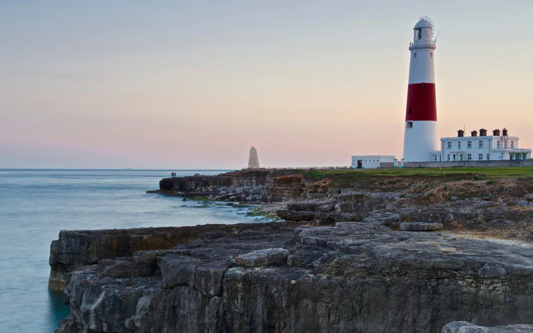 The Portland-Beal Lighthouse against the backdrop of the predawn sky in the United Kingdom