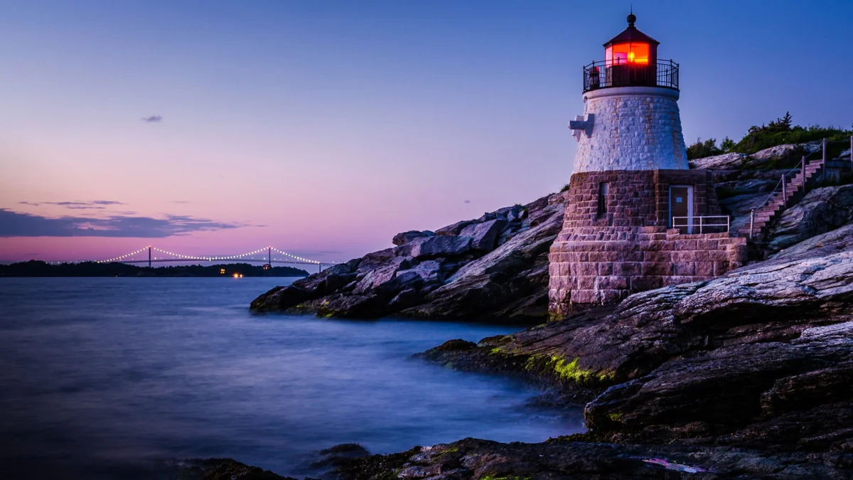 Castle Hill Lighthouse against the twilight sky in Newport