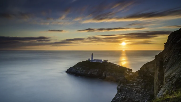 A golden sunset over South Stake Lighthouse in Wales